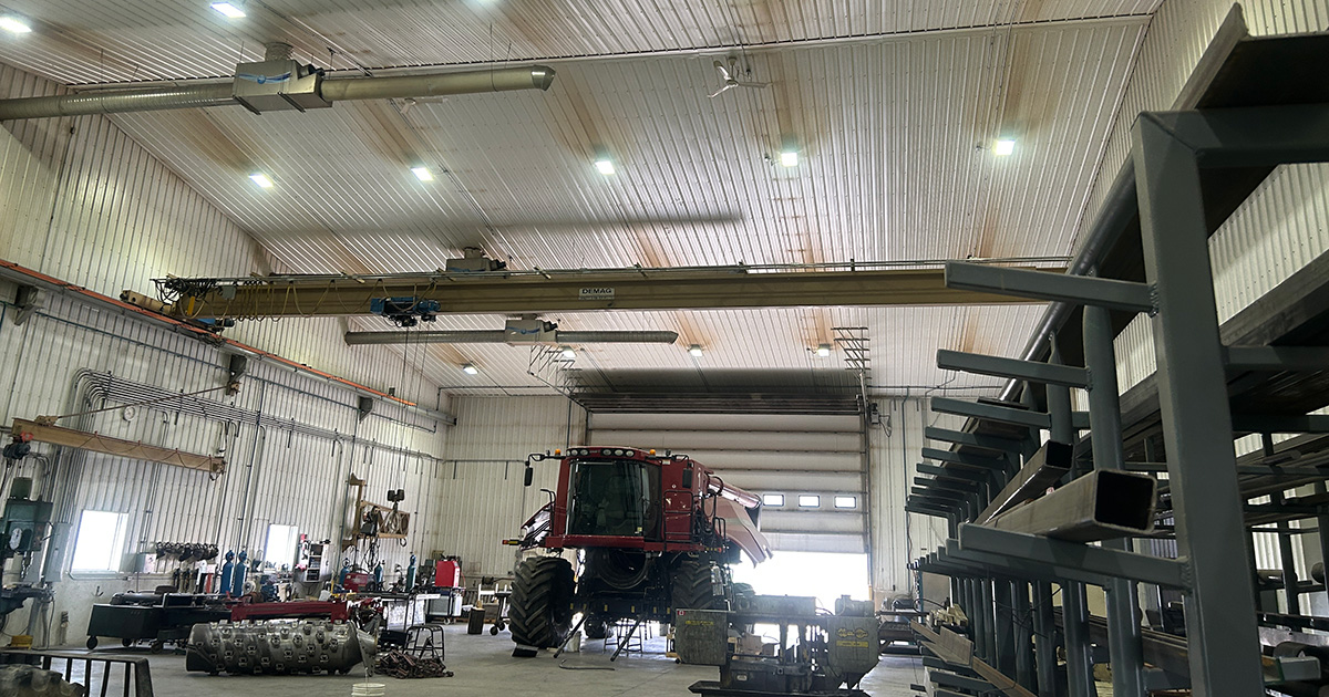 Dirty workshop ceiling showing condensation staining and grime buildup from underfloor heating with cold structural surfaces.
