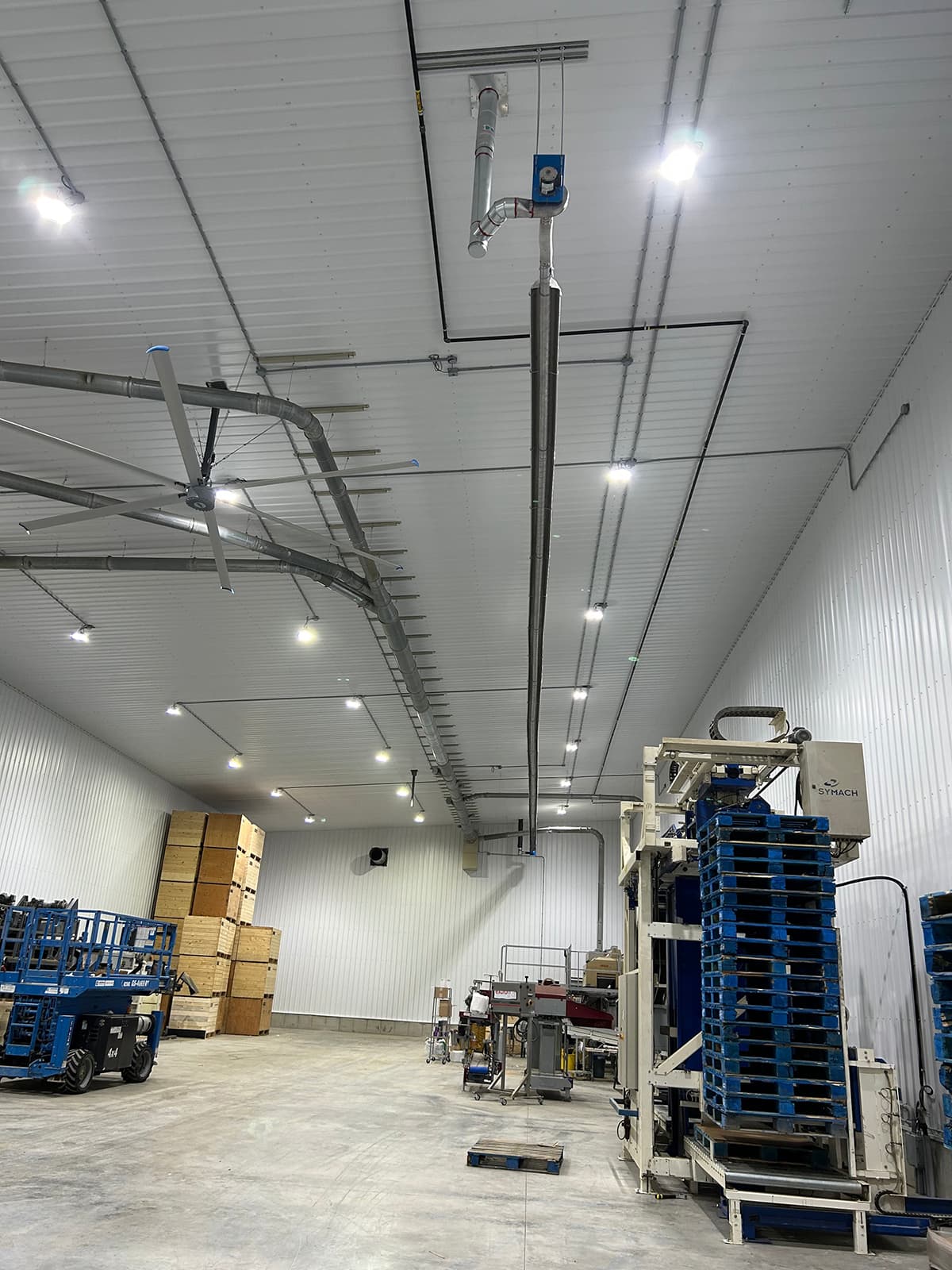 Interior of Keho Farms shop showing a 120-foot Reflect-O-Ray infrared radiant tube heating system running the full length of the ceiling